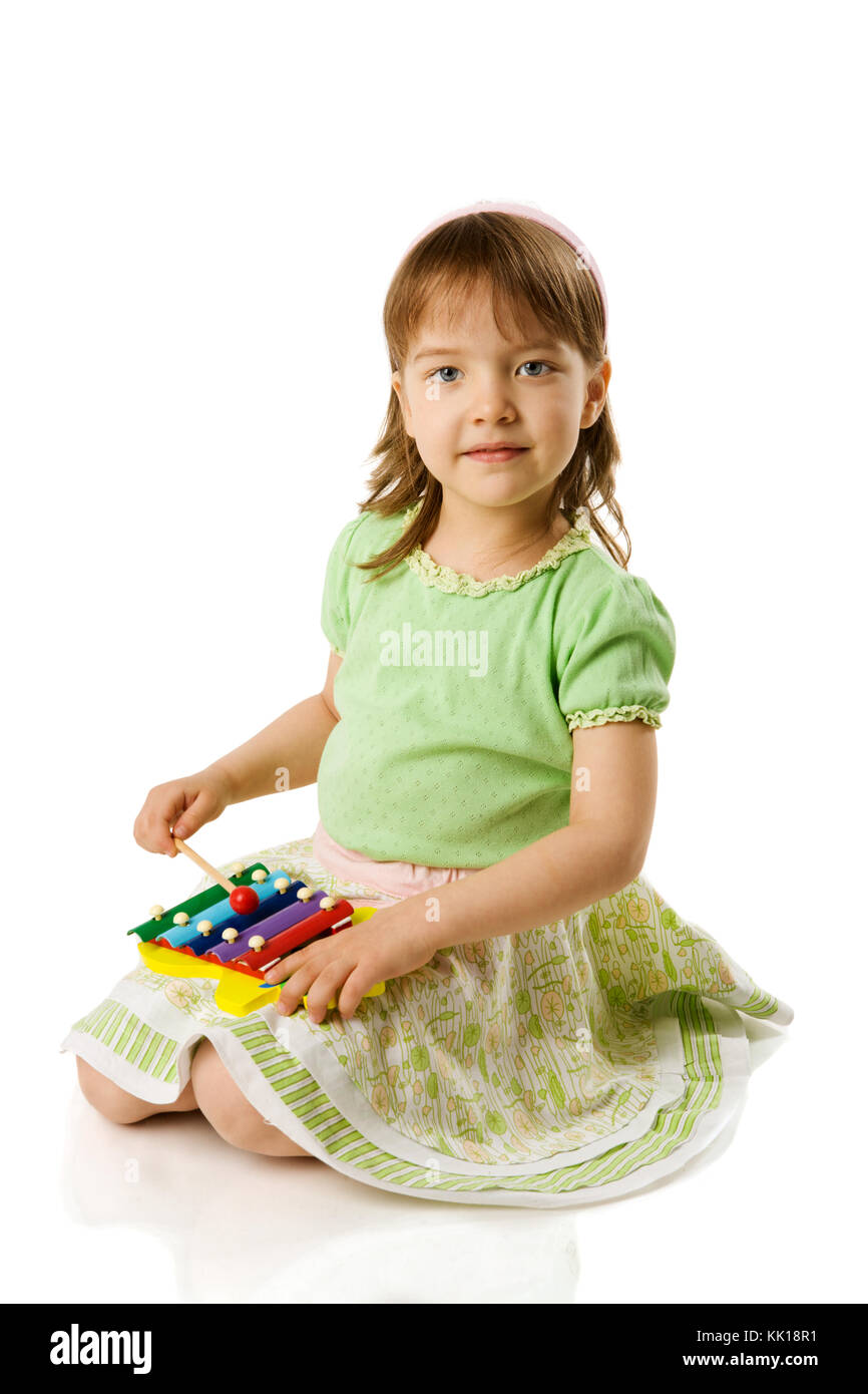 Girl playing on xylophone isolated on white Stock Photo