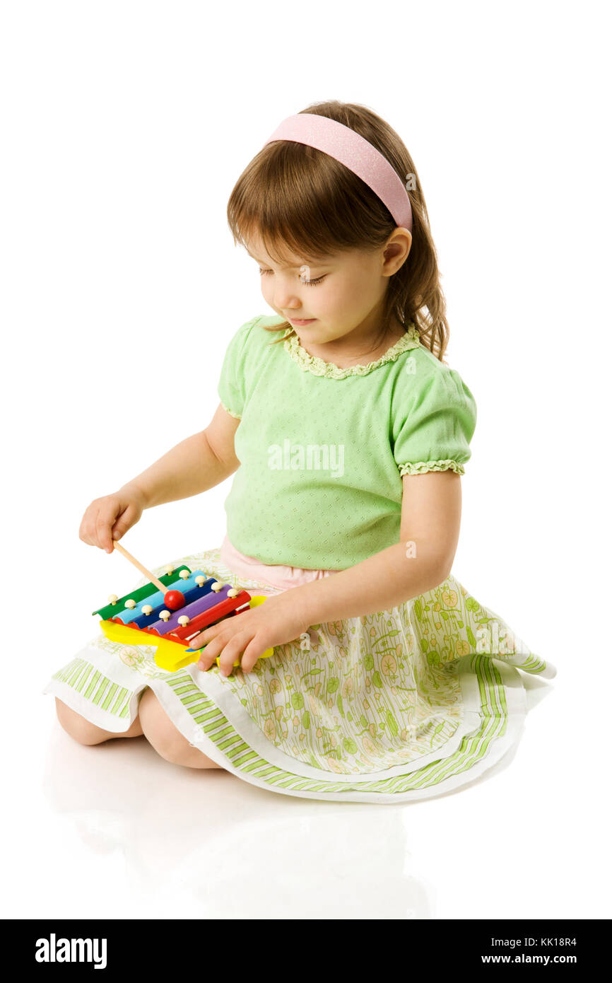 Girl playing on xylophone isolated on white Stock Photo