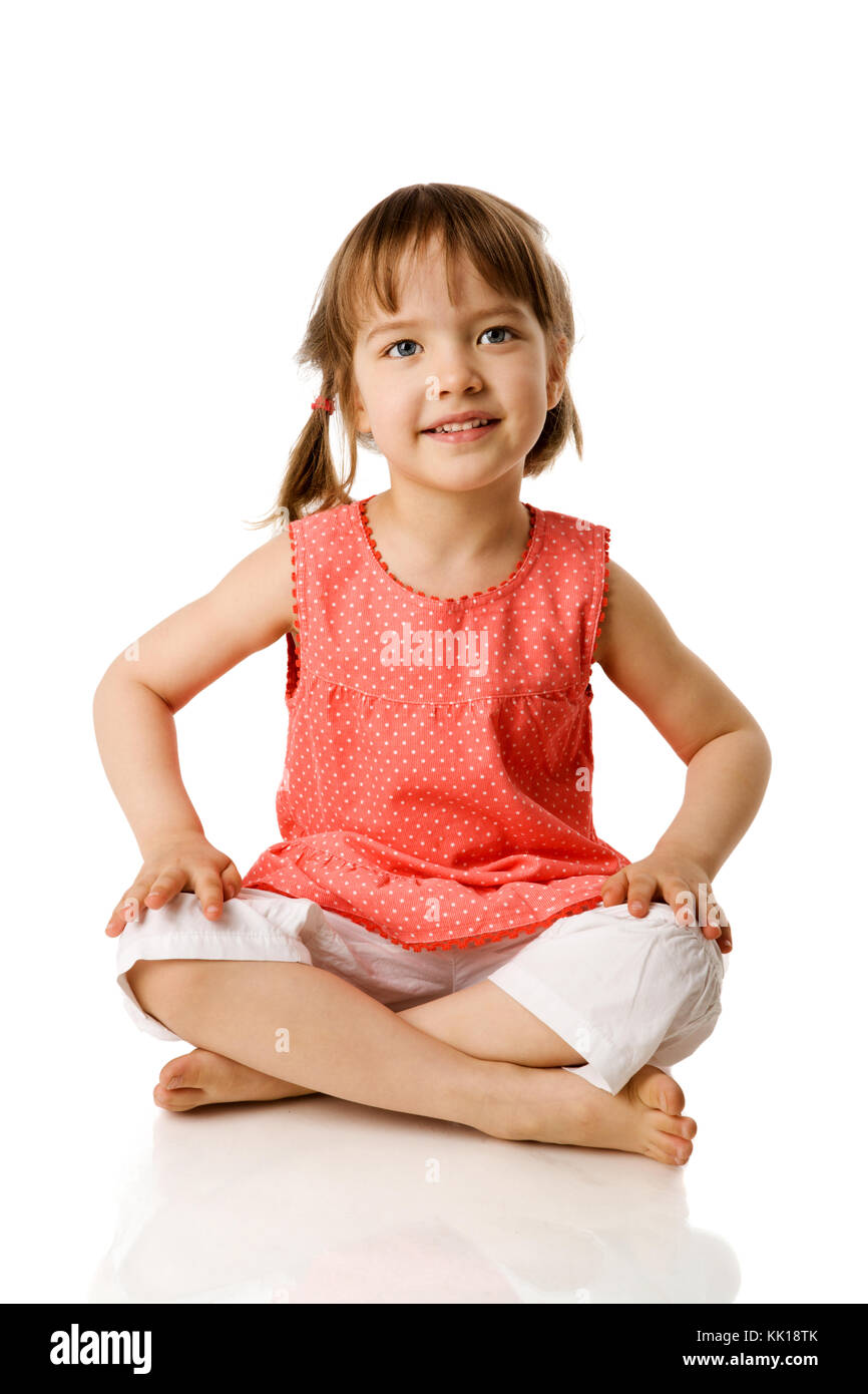 Happy Little girl sitting isolated on white Stock Photo Alamy