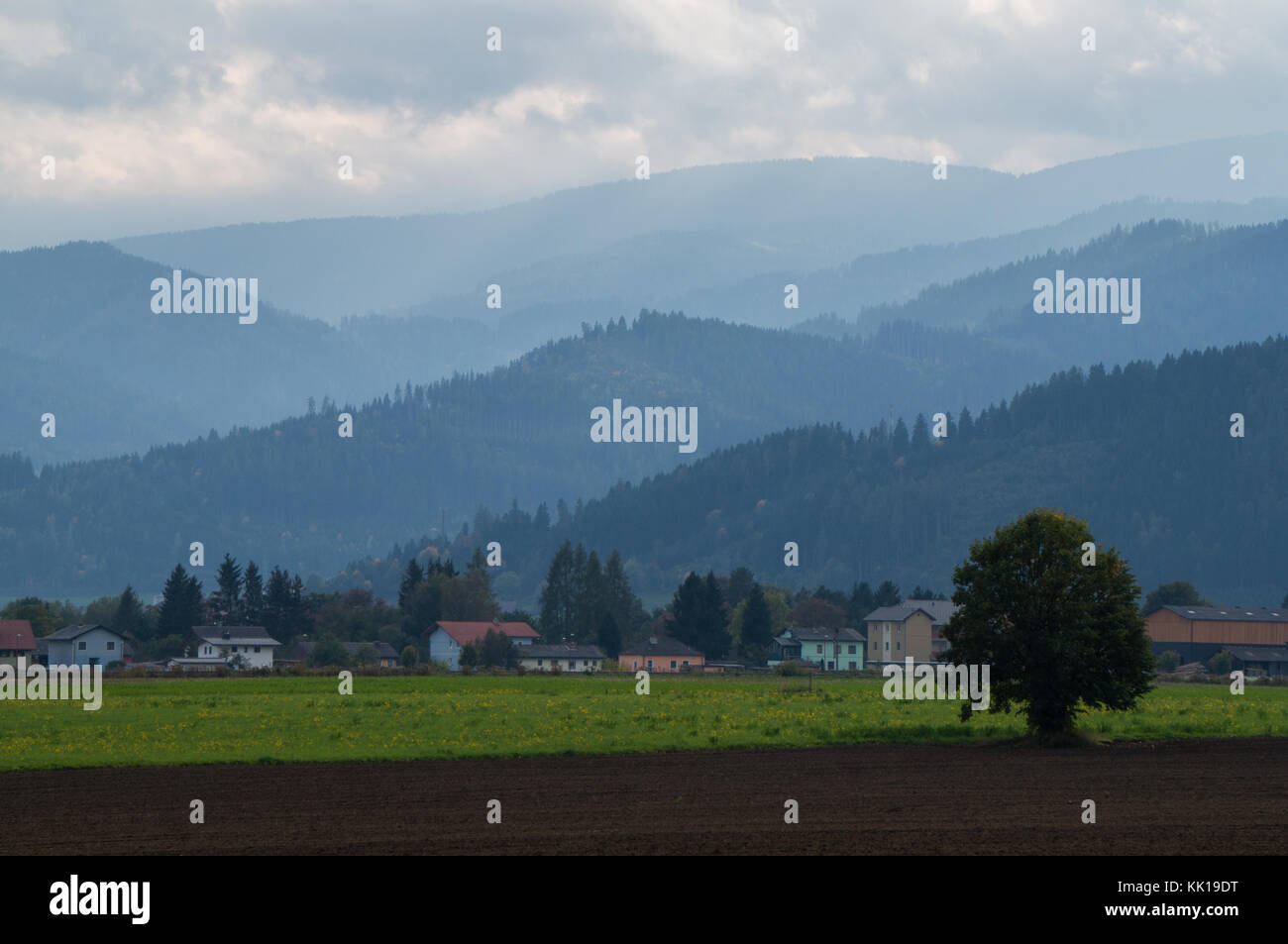 Arable land with hills and mountains in the background Stock Photo
