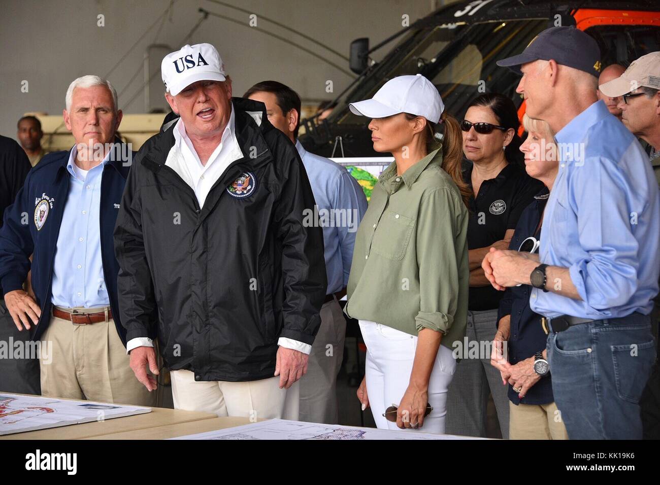 U.S. President Donald Trump speaks with first responders during a visit in the aftermath of Hurricane Irma September 14, 2017 in Ft. Meyers, Florida.  First Lady Melania Trump, center, Florida Governor Rick Scott, right, and Vice President Mike Pence, left, look on. (photo by Coast Guard News via Planetpix) Stock Photo