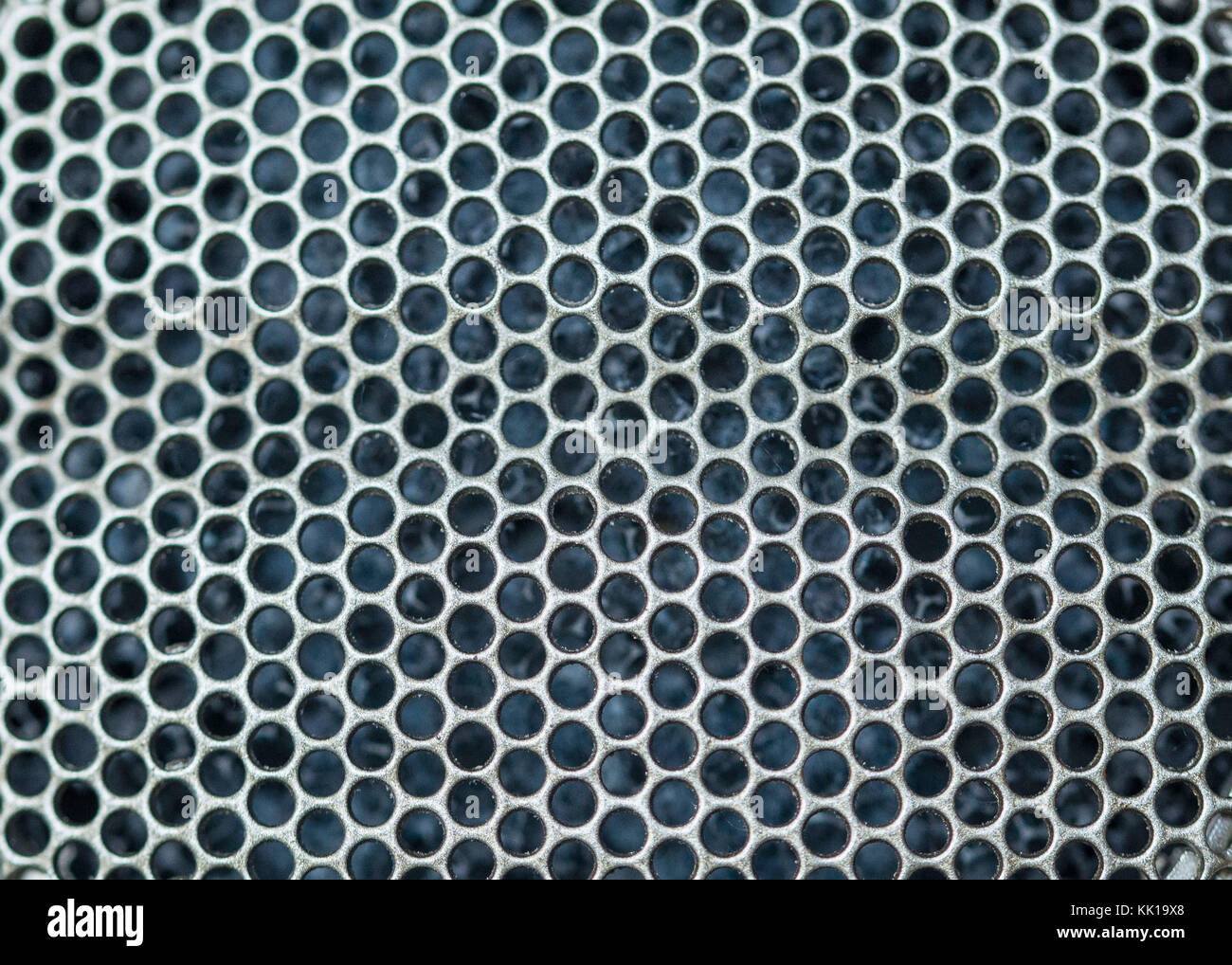 Texture honey comb close up steel pattern. Metal holes of mesh for steel pattern of equipment. Close up or honey comb pattern steel holes  equipent Stock Photo