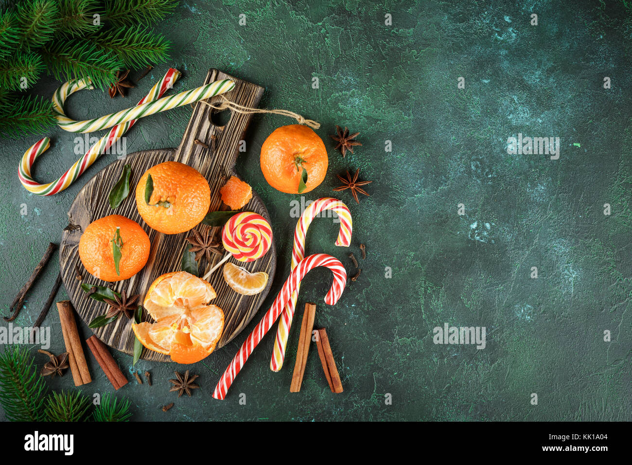 Fresh mandarins with leaves, candy canes and spices - cinnamon, anise ...