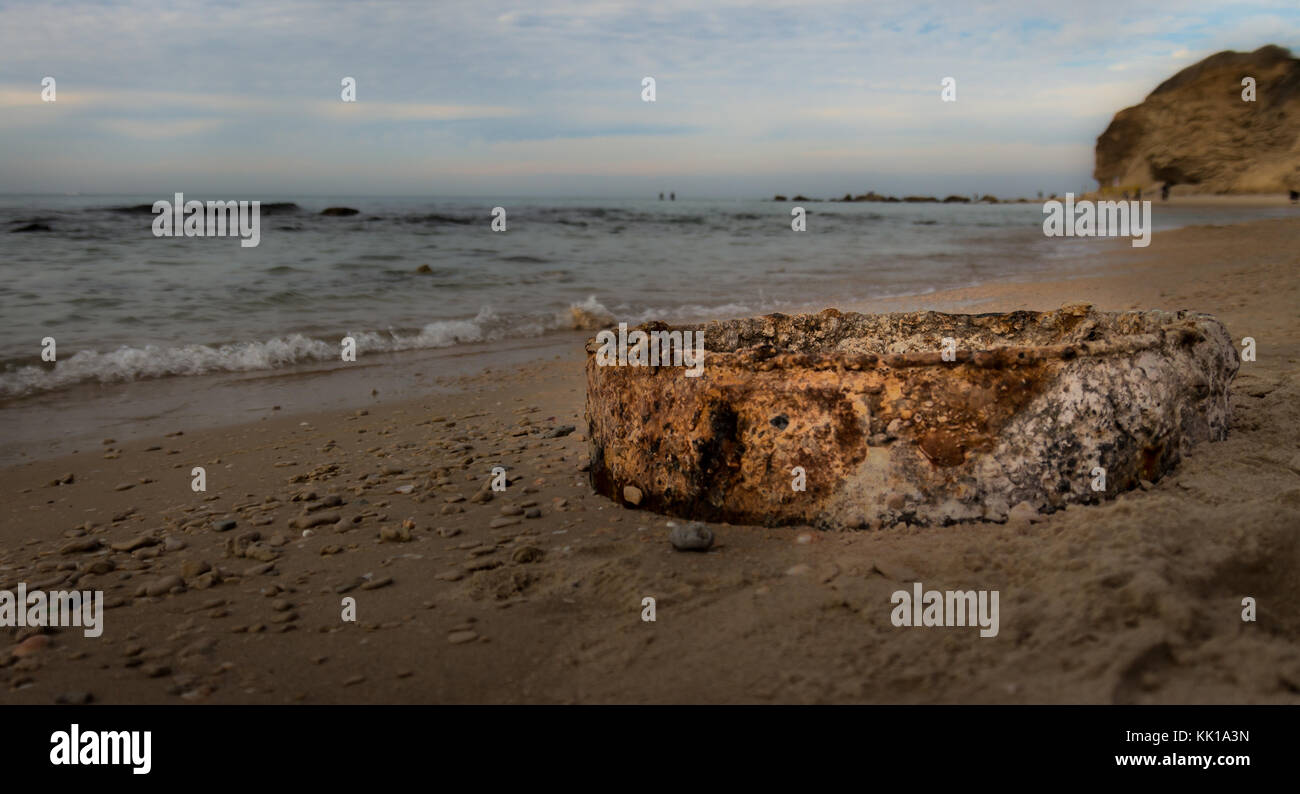 Rusty iron garbage on the beach Stock Photo
