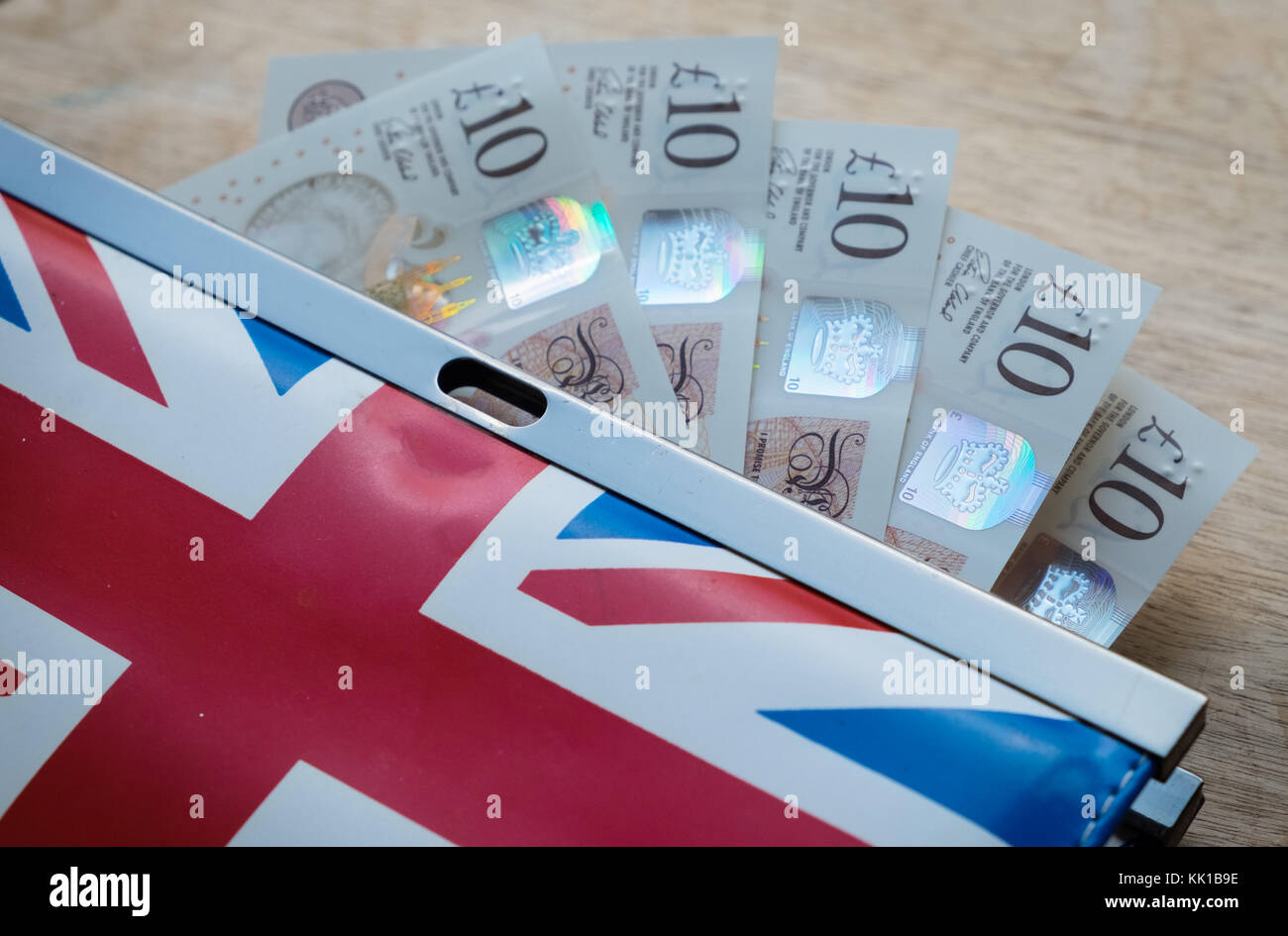 British money, five ten pound notes in purse with british flag design Stock Photo