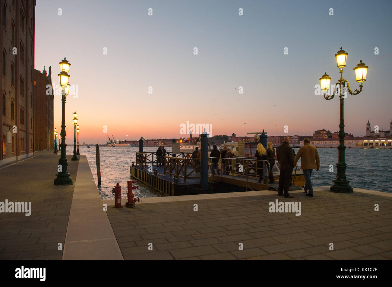 Vaporetto landing at dusk from Giudecca towards Dorsoduro in Venice Stock Photo