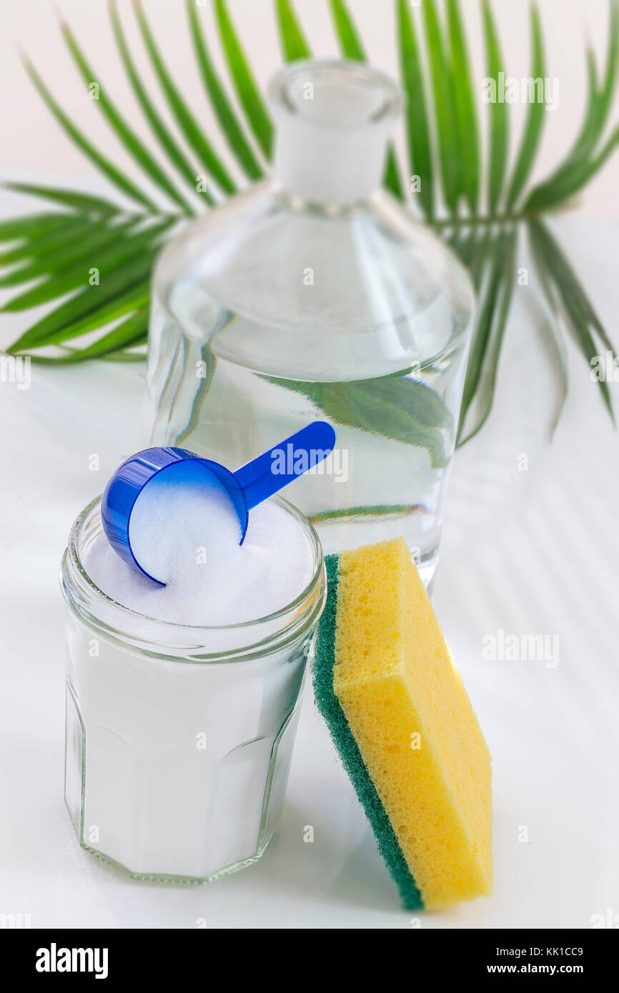 Eco-friendly natural cleaners baking soda, lemon and cloth on grean leaf and whithe background, Stock Photo