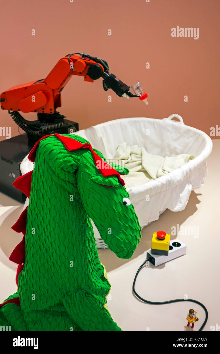 Robot Baby Feeder, kill switch to deactivate robot and dragon costume to make industrial robots more approachable Stock Photo
