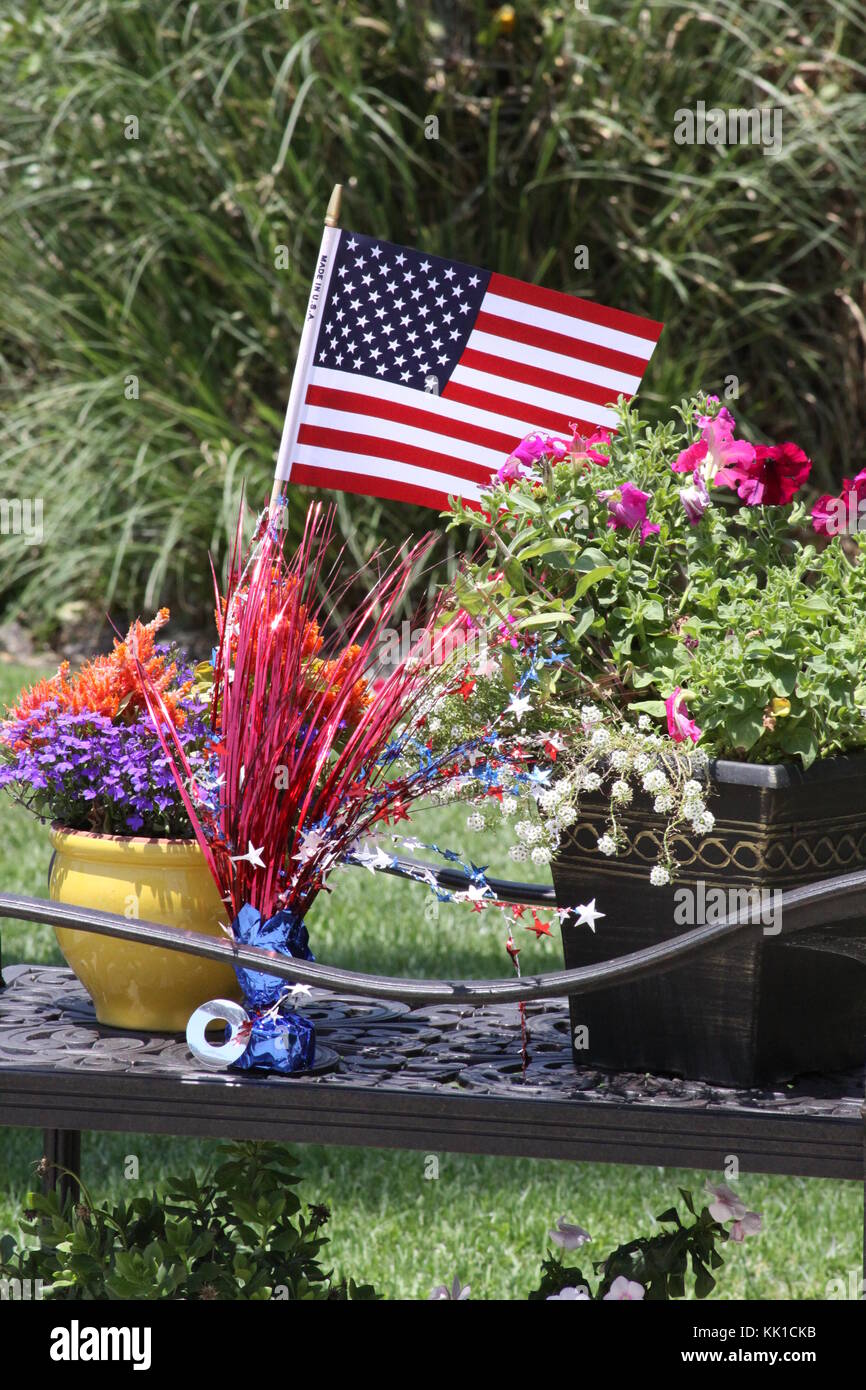 An American flag decorates a flower pot for 4th of July. Stock Photo
