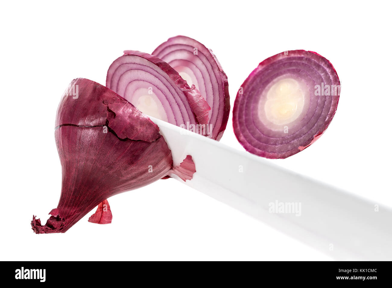 cutting onions with knife, closeup on white background Stock Photo