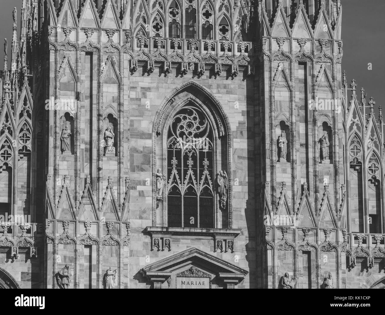 View of architectural details on the massive gothic cathedral Duomo, Milan, Italy. Black and white photography. Stock Photo