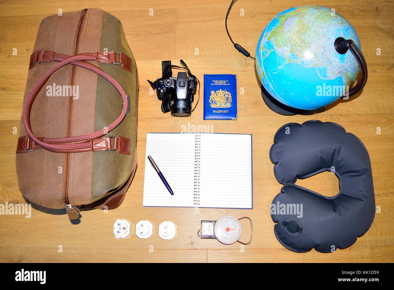 Flat lay of a travel concept, depicting a globe and deciding where to go next.  Creating a bucket list Stock Photo