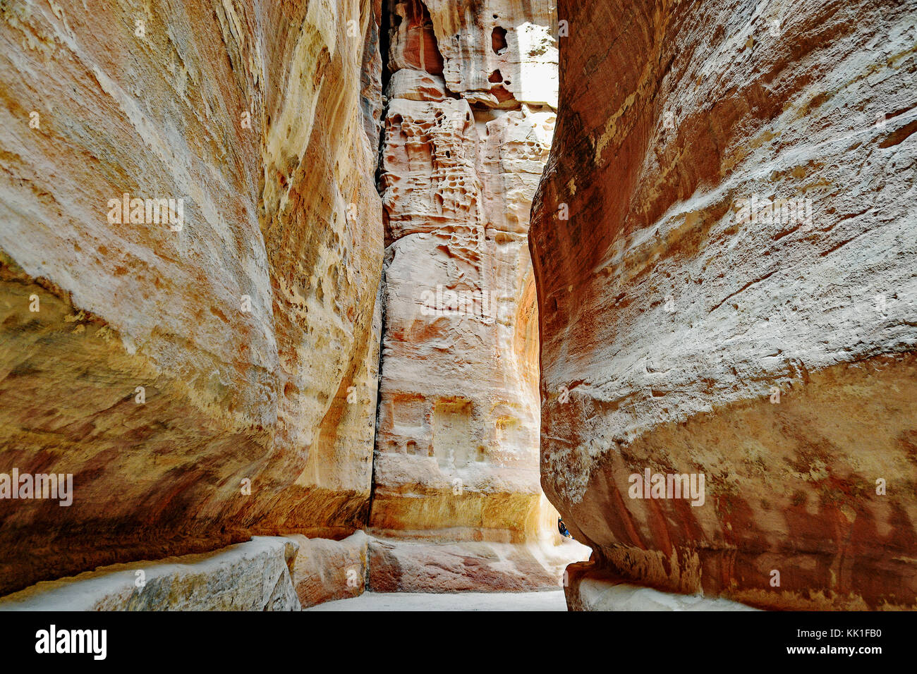 Pathway to the ancient city of Petra, Jordan. The pathway is a Siq - narrow gorge carved by water flow. Stock Photo