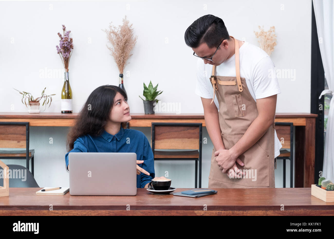 asia woman customer complaining to waiter about food in cafe restaurant,unhappy emotion service in coffee shop Stock Photo