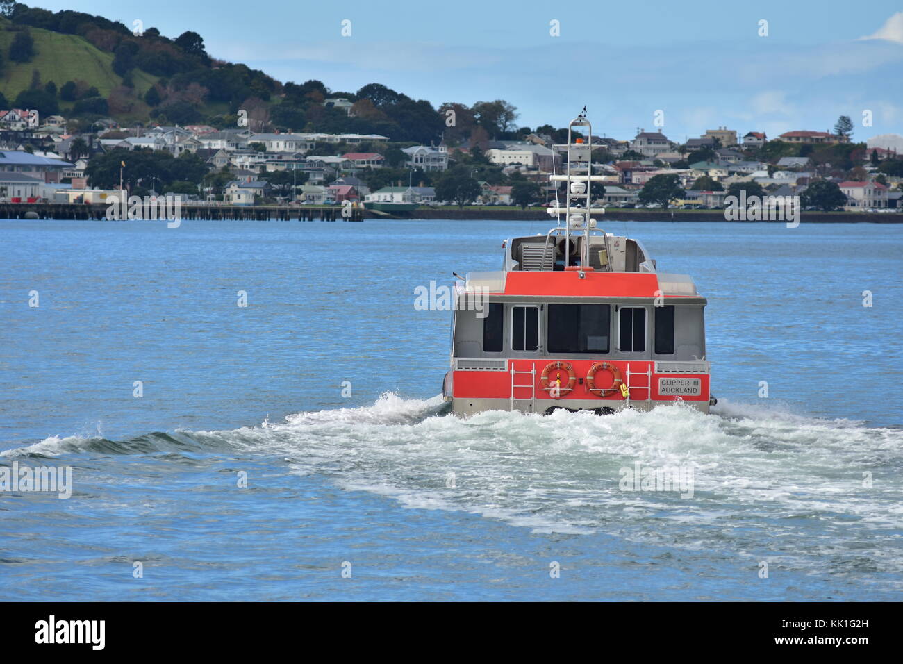 Steel catamaran ferry leaving Auckland CBD and heading towards Devonport. Stock Photo