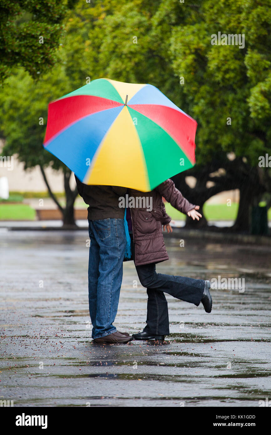 Close up image of a couple in love standing under an umbrella in the ...