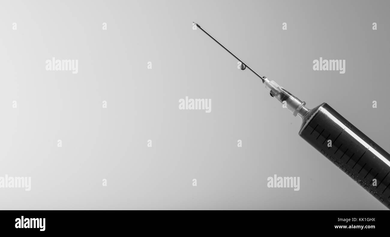 Close up macro view of a syringe / syringes full of coloured fluid