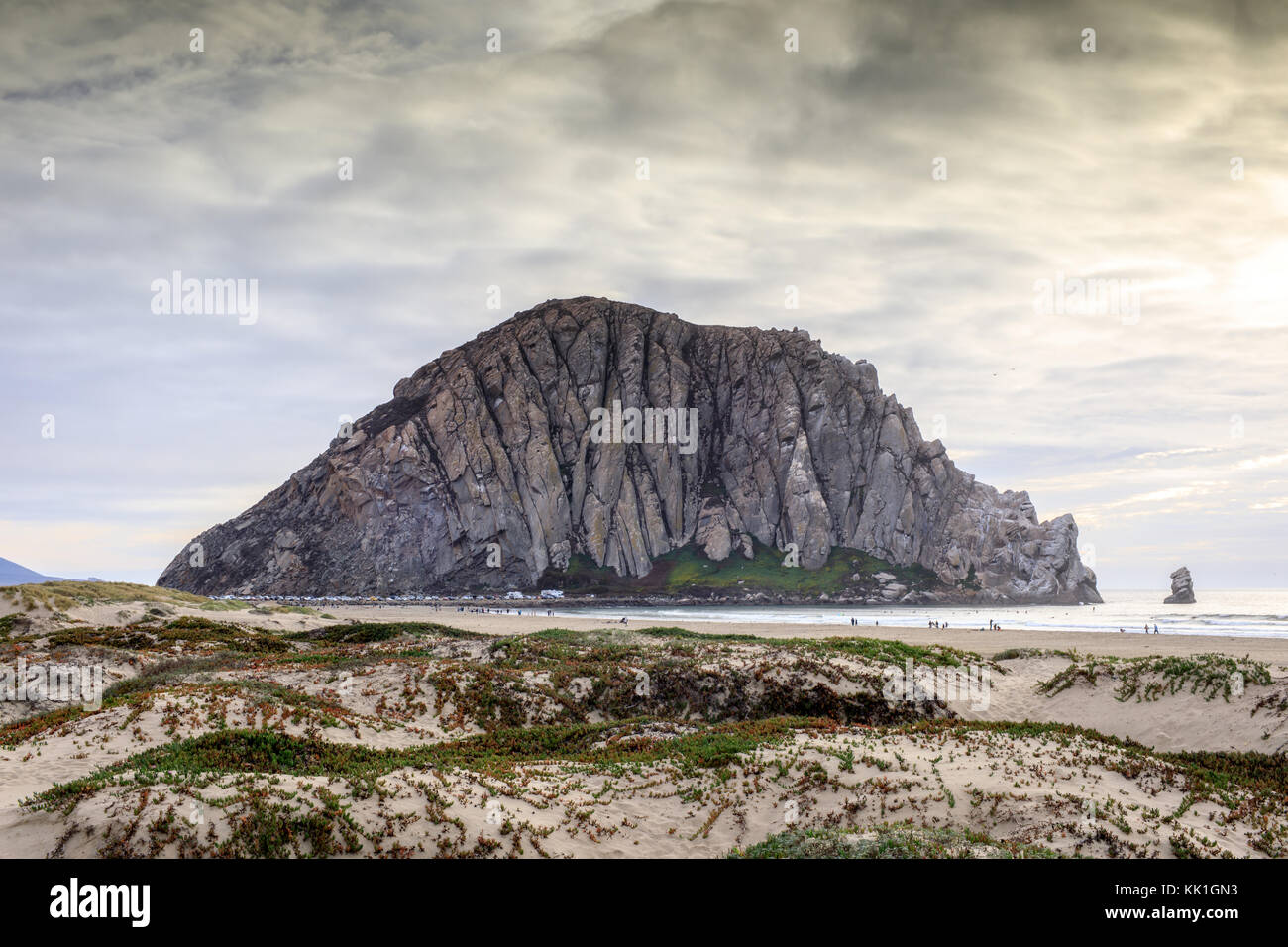Morro Rock with Sandy Dunes of Morro Creek Beach. Stock Photo