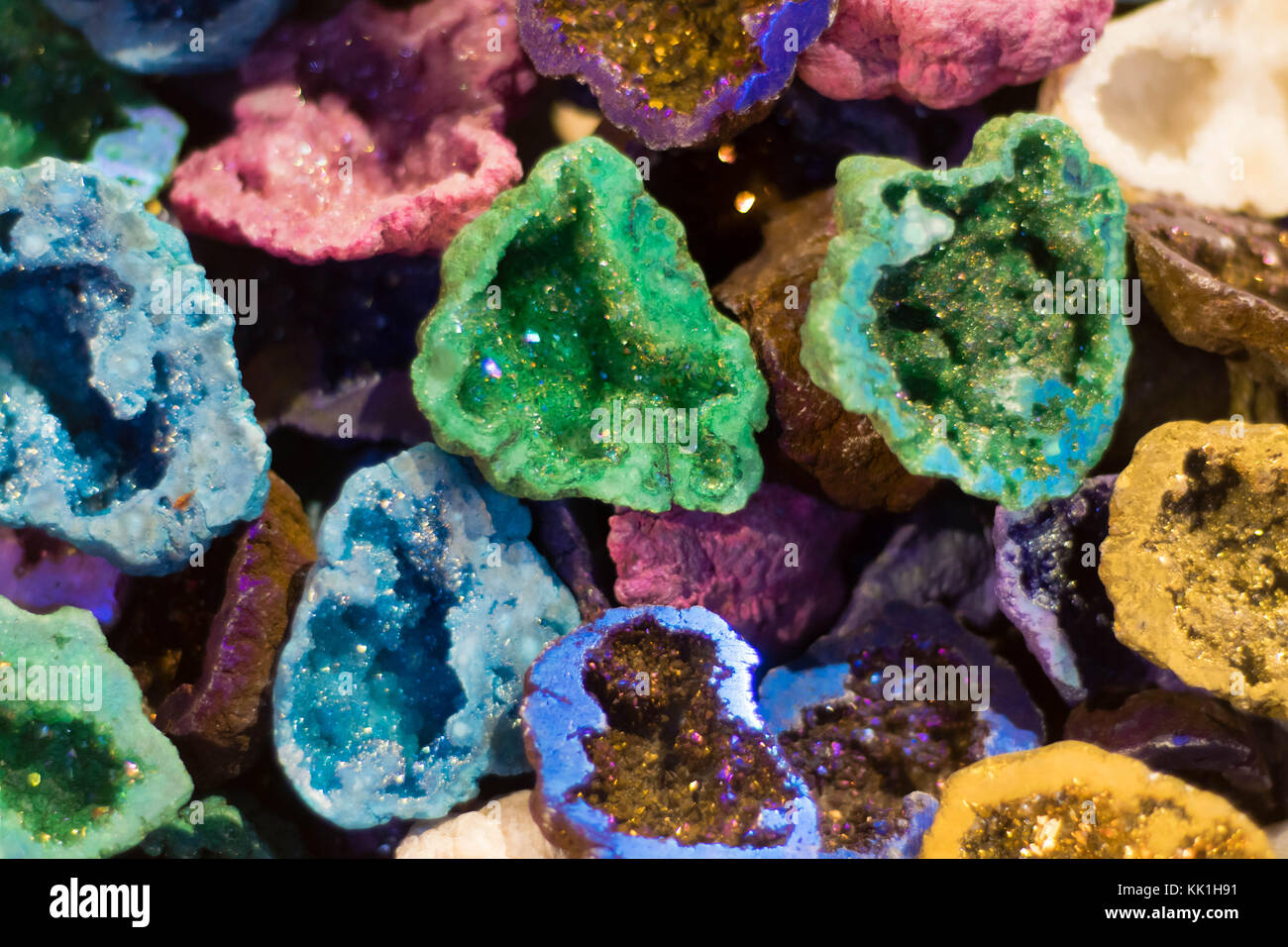 Colourful geodes cut open. Vibrant geological structures showing crystalline minerals within Stock Photo