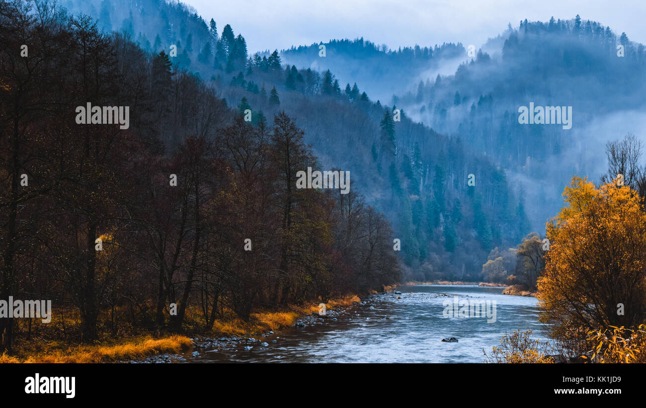 color orange blue autumn dawn landscape with fog Stock Photo - Alamy