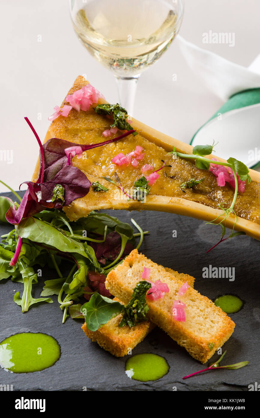beef bone marrow with chimichurri sauce and french onion Stock Photo