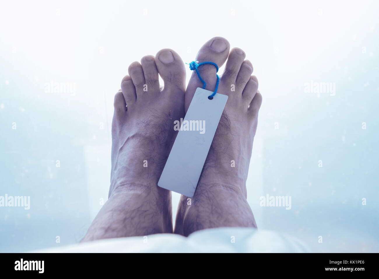 Feet of dead male person in morgue, close up of selective focus Stock Photo