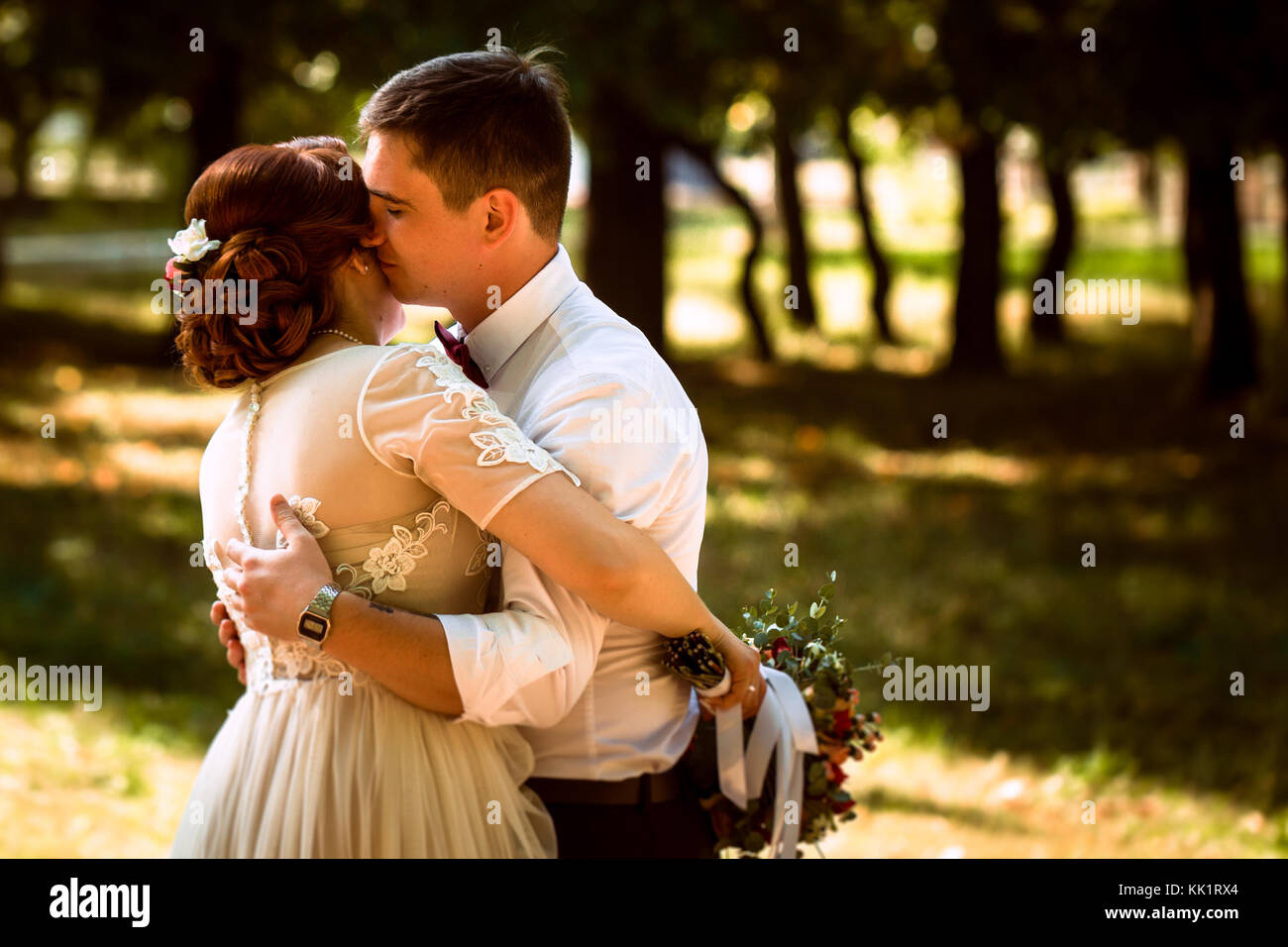 The bride and groom in the background of park trees Stock Photo - Alamy