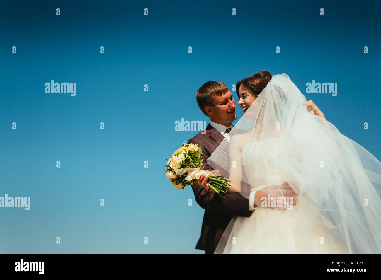 young bride and groom couple on the sky background Stock Photo - Alamy