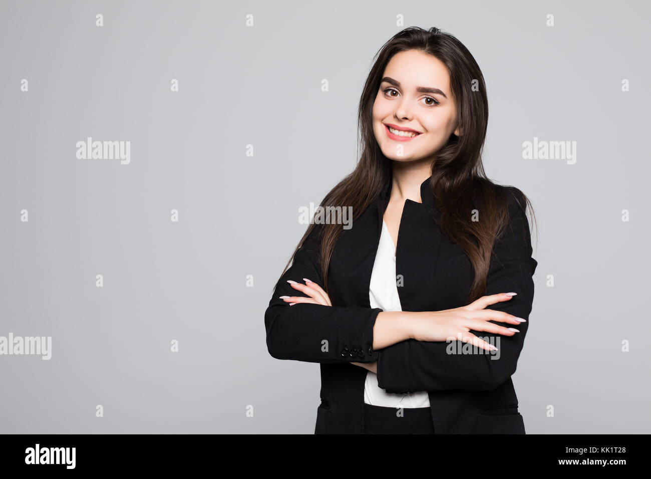 Portrait of wonderful young business woman on gray background with copy ...