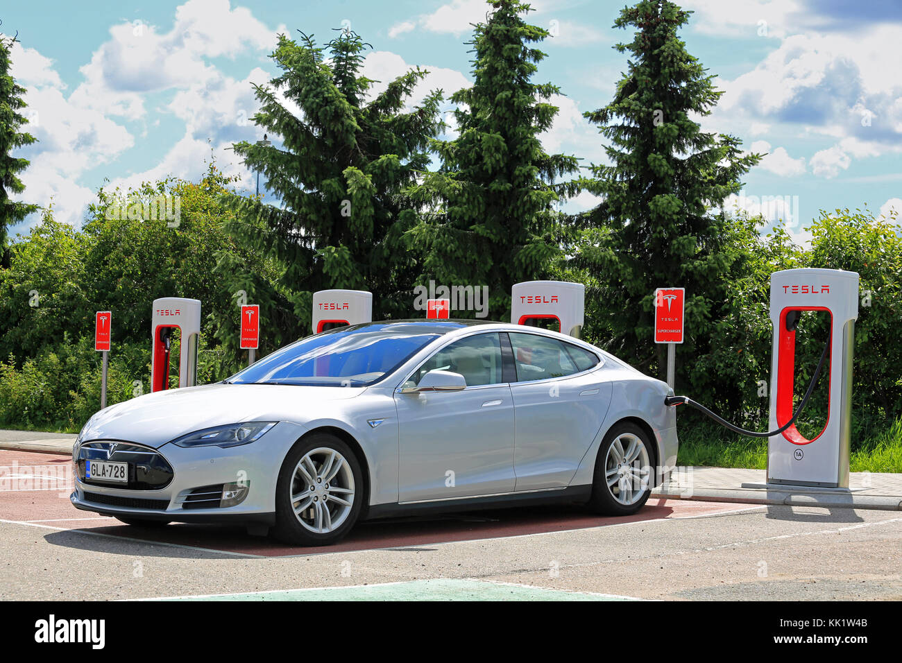 PAIMIO, FINLAND - MAY 14, 2015: Tesla Model S is being charged at Tesla  Supercharger station. Charging the battery from 10 to 80 percent takes  about 4 Stock Photo - Alamy