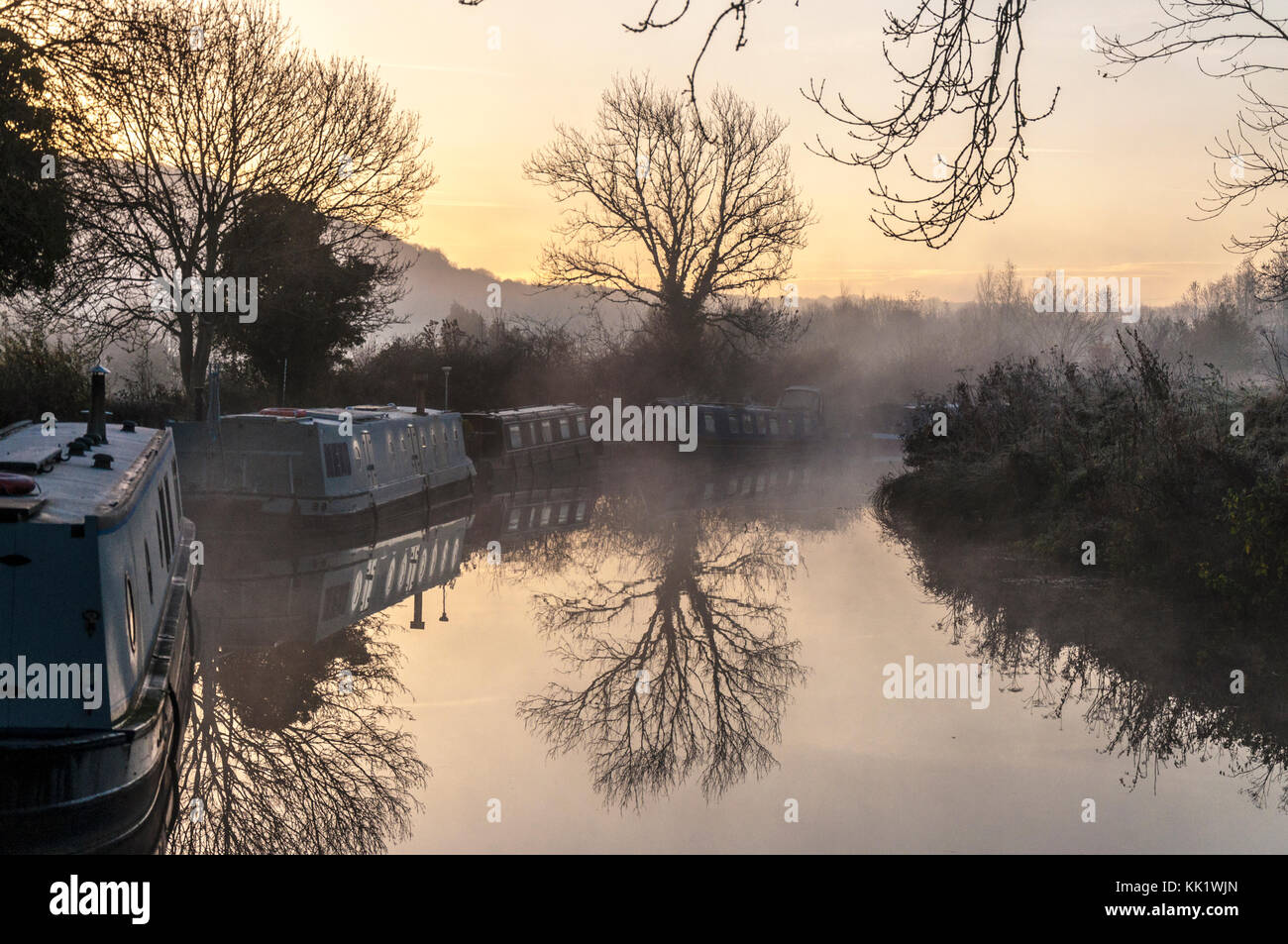 Misty early morning reflections on Kennet and Avon Canal at Bathampton, Somerset, England, UK Stock Photo
