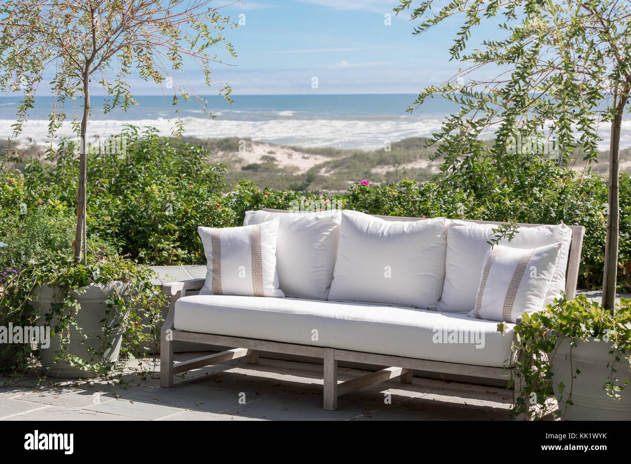 out door couch on an East Hampton patio with atlantic ocean in background in east hampton, ny