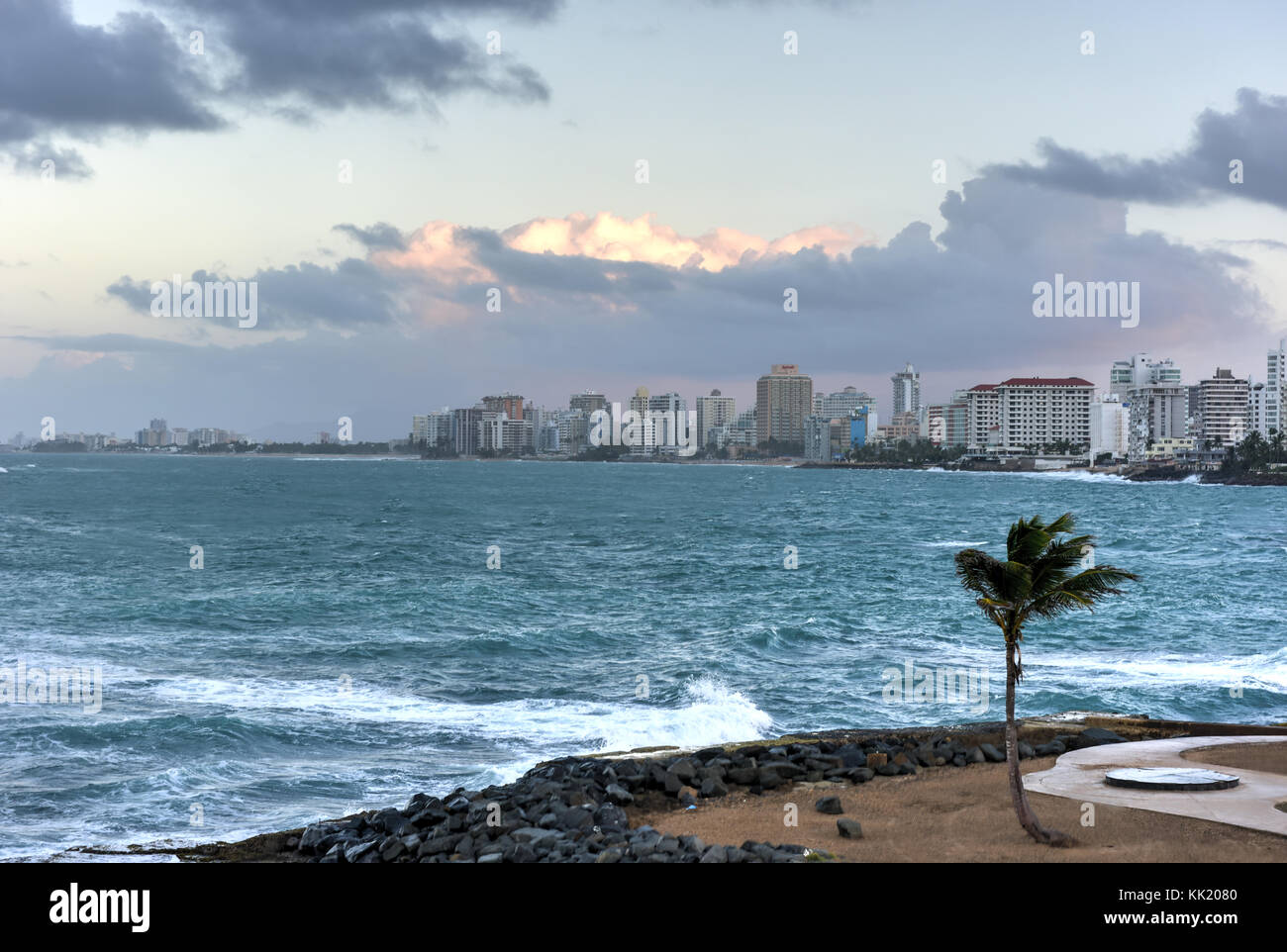 Beach with waves crossing against the rocks off of Condado, San Juan, Puerto Rico. Stock Photo