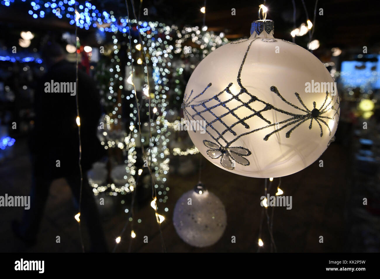 A Lit Christmas Bauble Hanging From The Ceiling Of The Shop