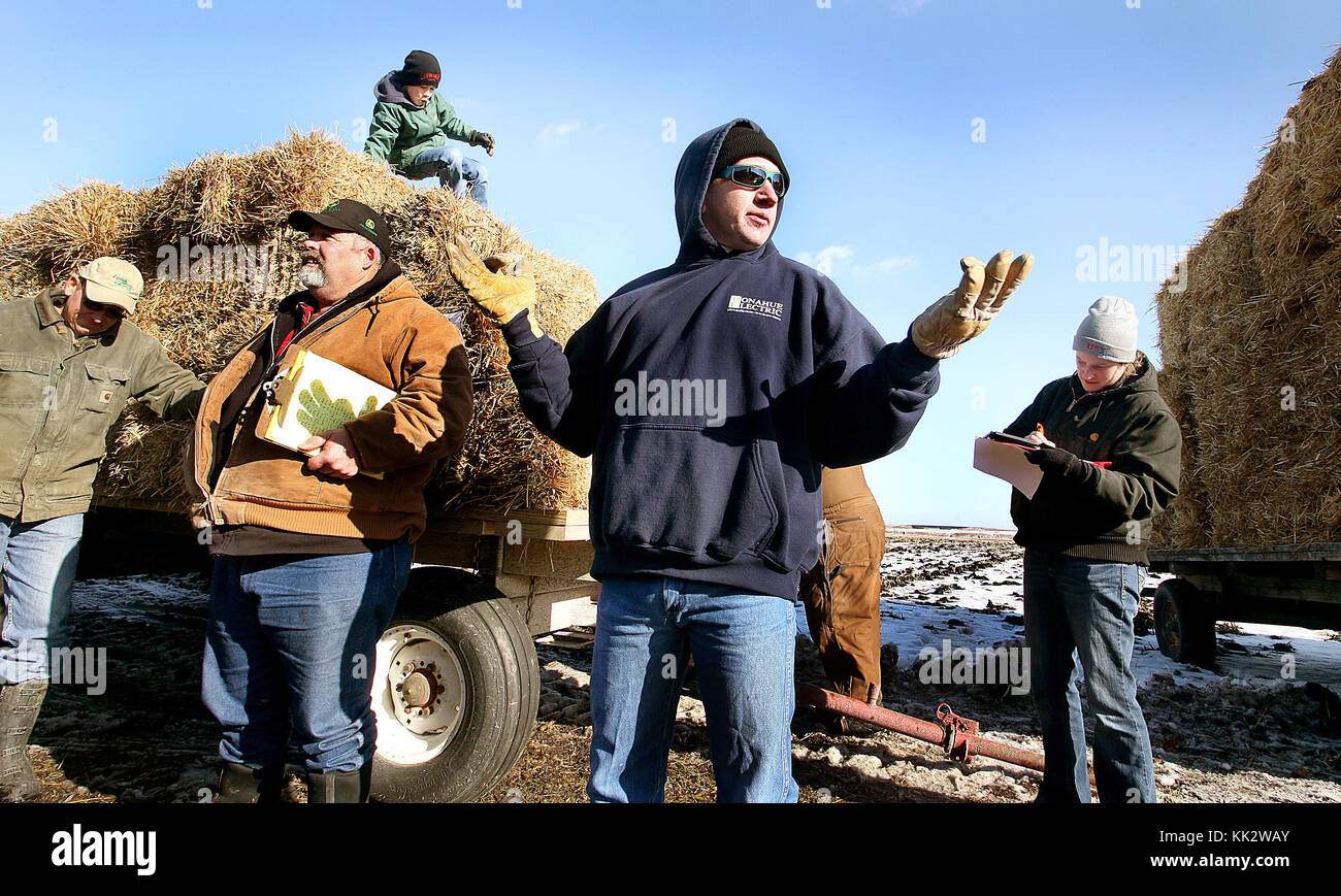 Blue Grass, Iowa, USA. 11th Jan, 2014. Auctioneer Chad Claussen, center