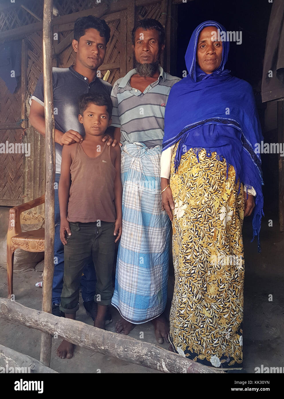 Kutupalong, Bangladesh. 28th Nov, 2017. The Hamza family stands in front of their house in the Rohingya refugee camp in Kutupalong, Bangladesh, 28 November 2017. 25-year-old Ullah Hamza (L) was one of the first children to be born in 1992 in the newly opened camp. Credit: Nick Kaiser/dpa/Alamy Live News Stock Photo
