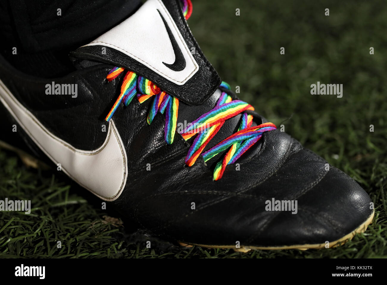 Rainbow coloured laces on Nike branded football boots at Loftus Road,  London Stock Photo - Alamy