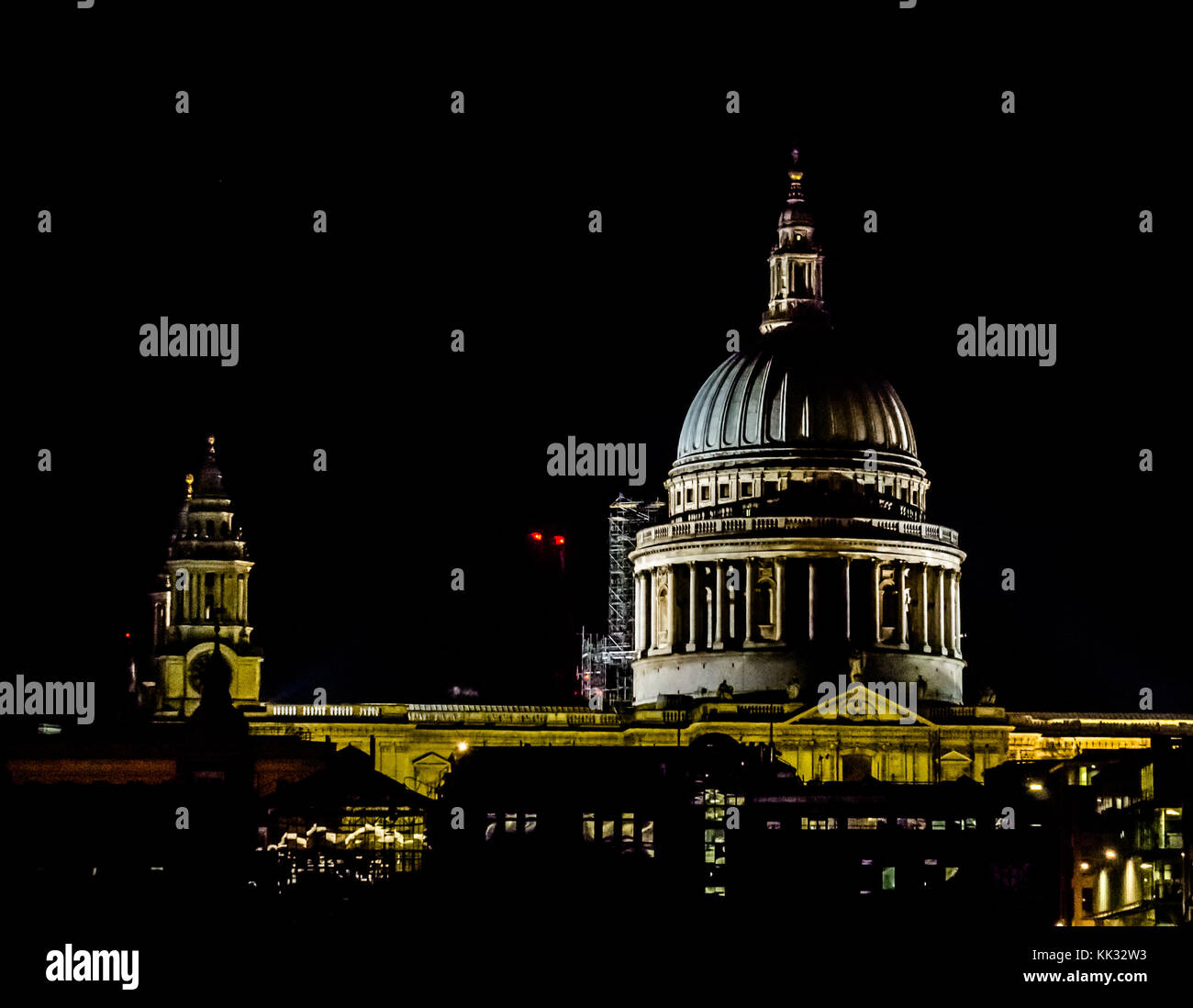 View of St Pauls Cathedral dome lit up at night with shadows of spires, London, England, UK Stock Photo