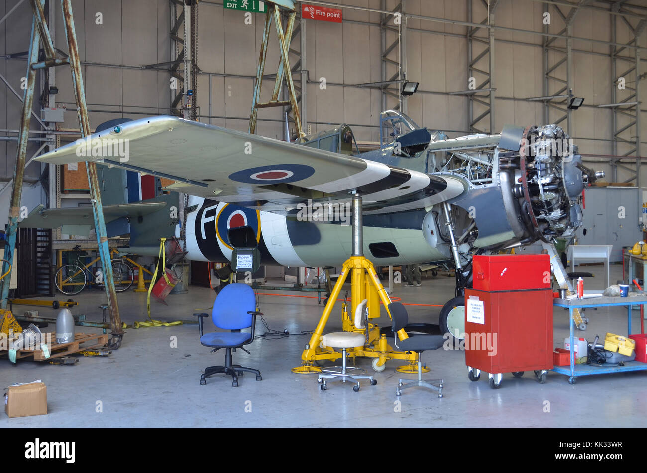 Grumman Wildcat FM2, built by General Motors, in Royal Navy Fleet Air Arm markings, undergoing maintenance by The Fighter Collection, Duxford, UK. Stock Photo