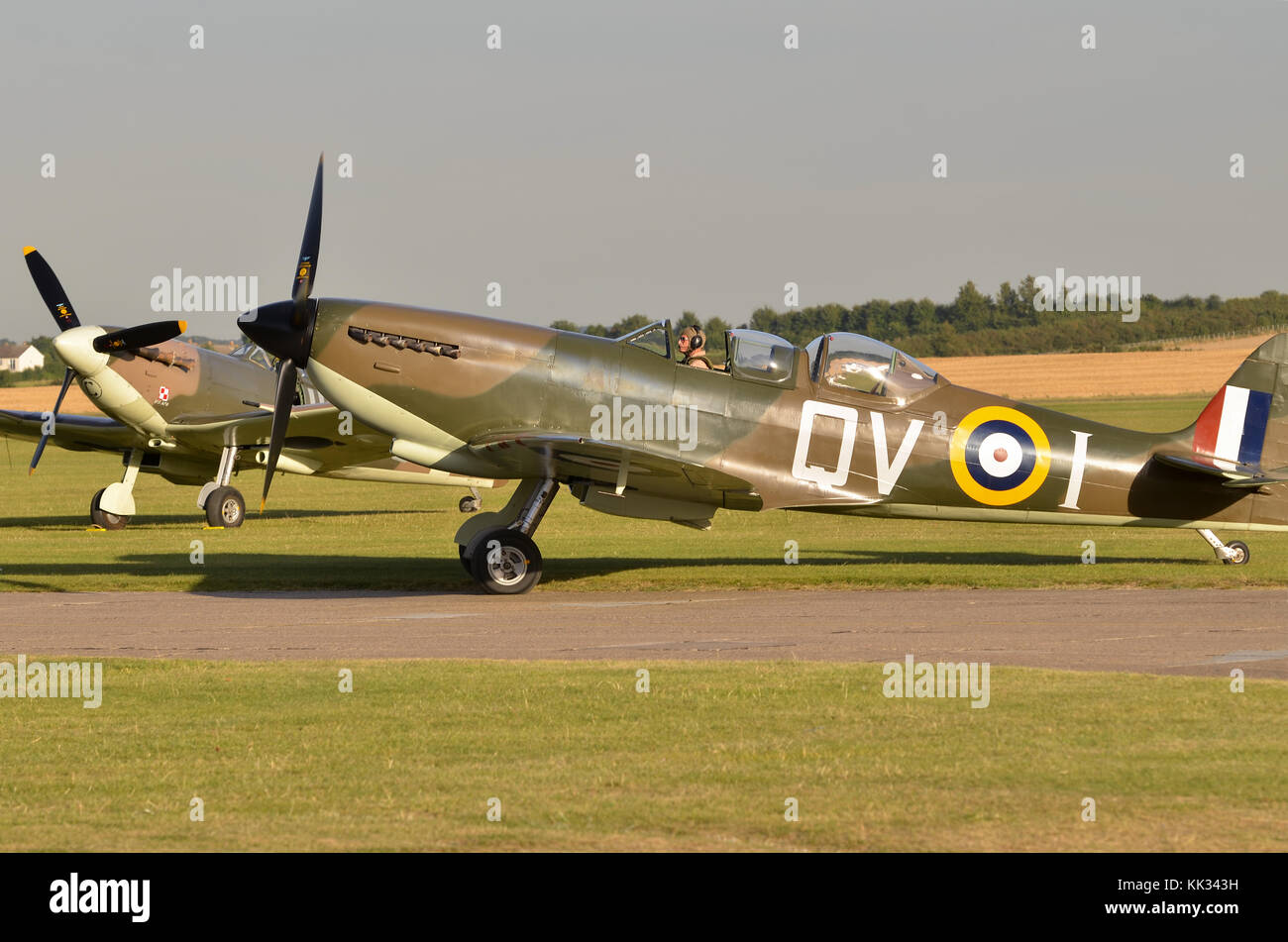 Spitfire Mk.IXT, RAF markings, Duxford, UK. Spitfire Mk. Vb parked behind. Stock Photo