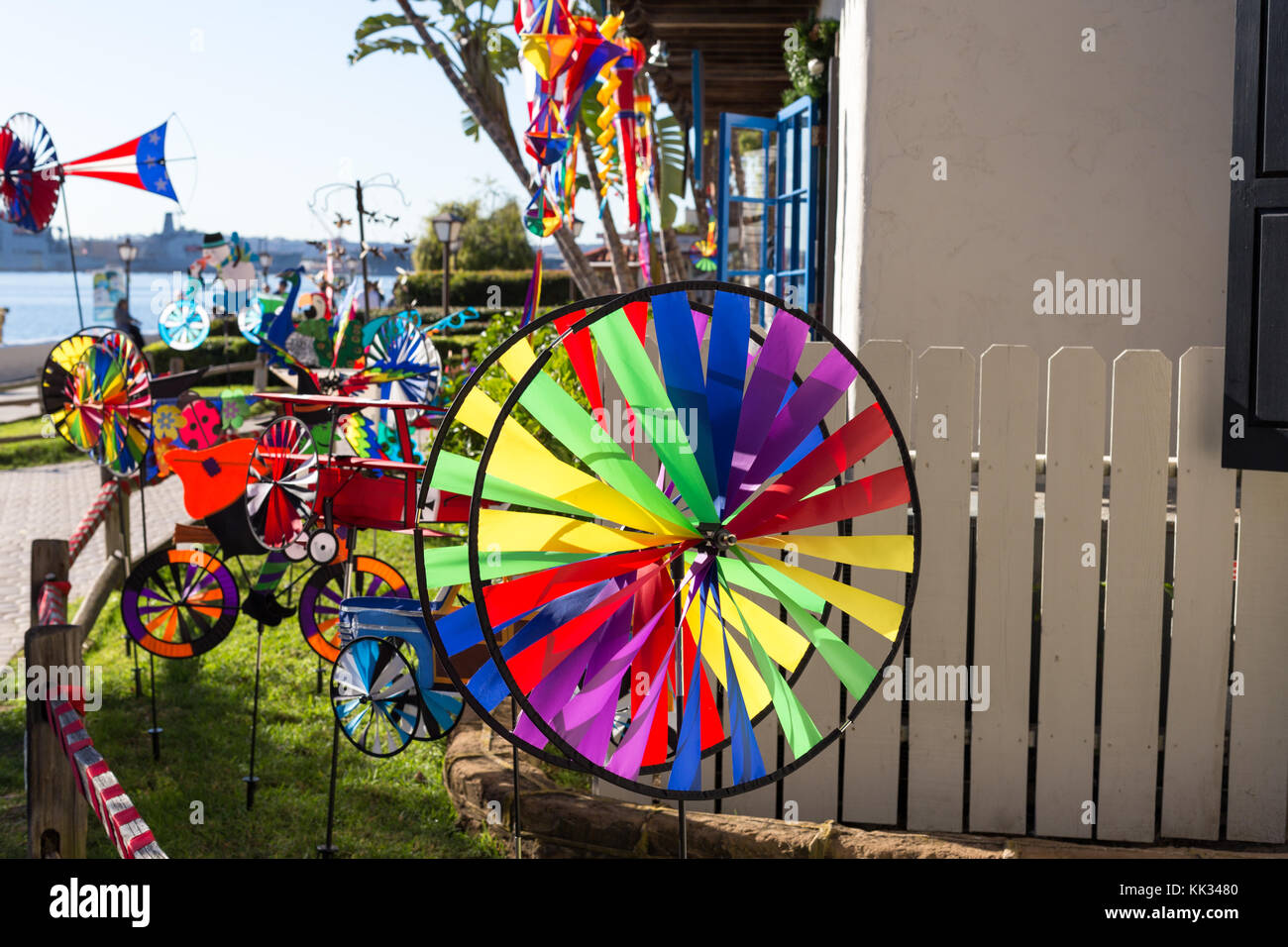 Colorful flags and wind spinners outside of a shop in Seaport Village, San Diego, California, USA Stock Photo