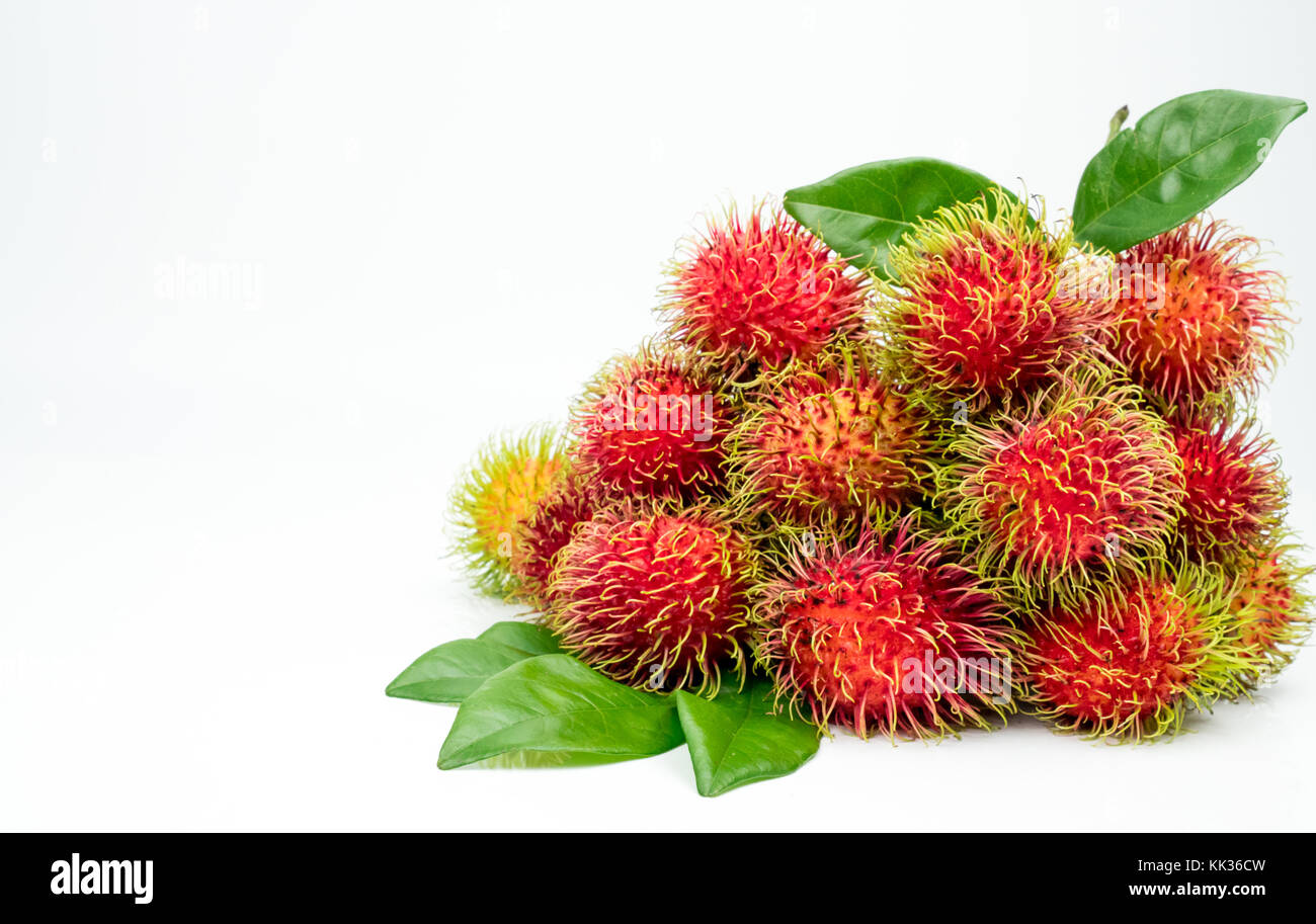 Fresh red ripe rambutan (Nephelium lappaceum) with leaves isolated on ...