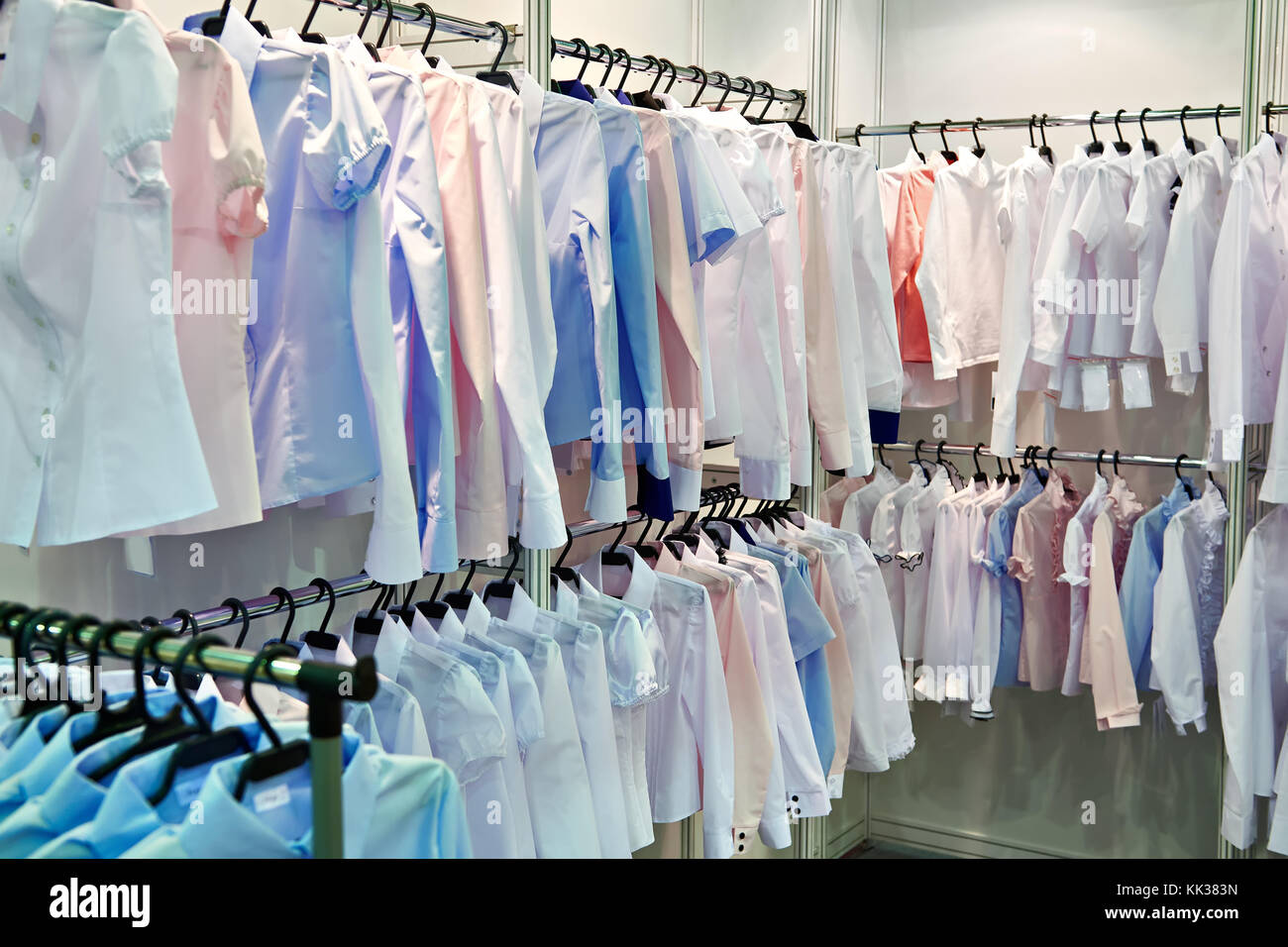 Women's blouses and shirts on the hanger in the store Stock Photo