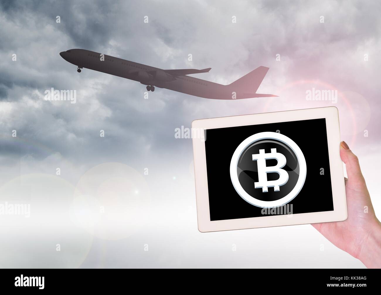 Digital composite of Airplane and Bitcoin icon on tablet in hand Stock  Photo - Alamy