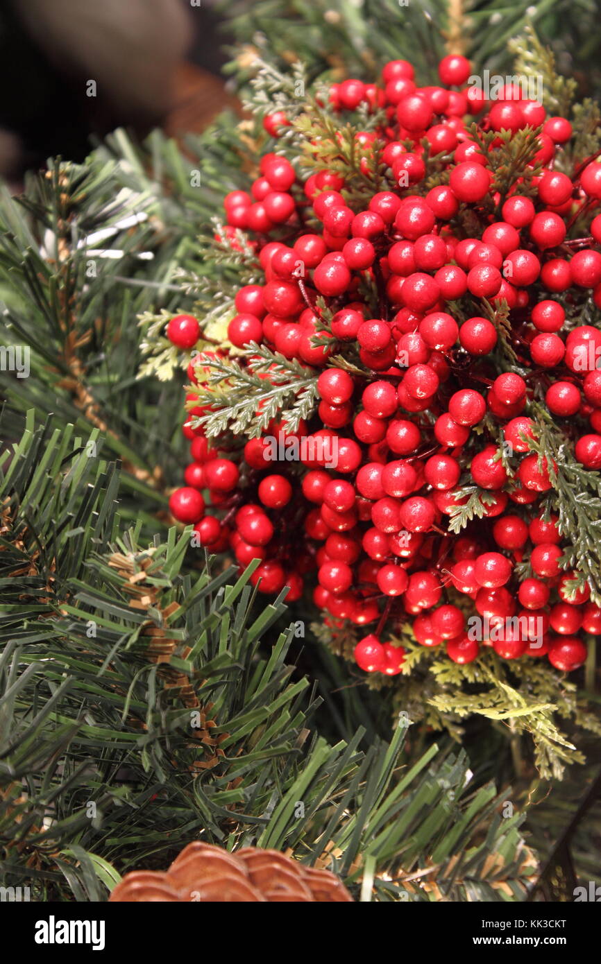 Christmas table decorations with holly, pine cones, mistletoe, cedar cypress and juniper leaf springs Stock Photo