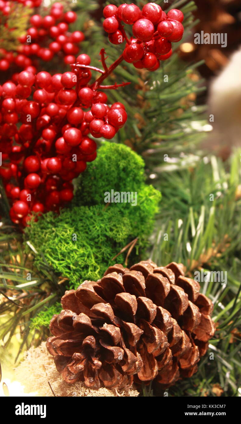 Christmas table decorations with holly, pine cones, mistletoe, cedar cypress and juniper leaf springs Stock Photo