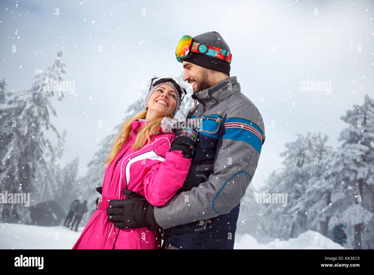 Happy couple in love on snowy nature together Stock Photo - Alamy