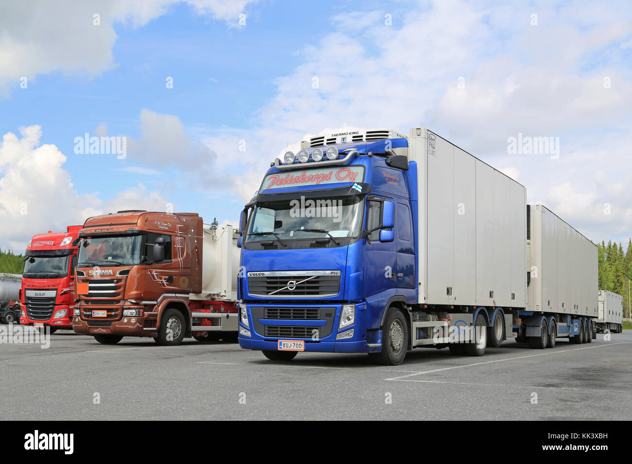 HIRVASKANGAS, FINLAND - JUNE 20, 2015: Volvo FH, Scania and DAF trucks at a truck stop on Midsummer Day. Road transport goes on throughout the Finnish Stock Photo