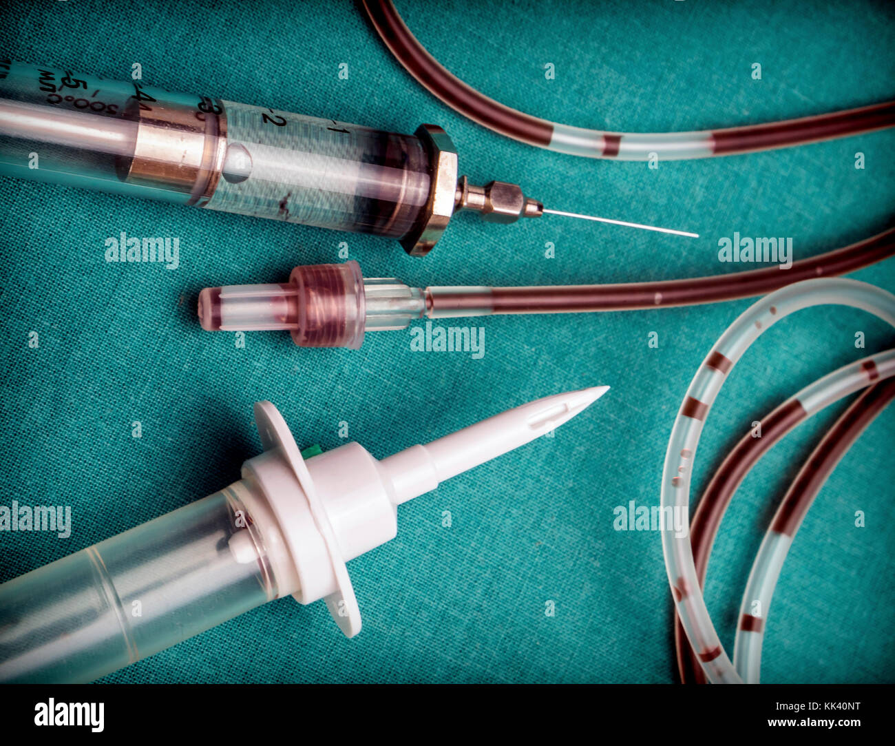 Drip irrigation system with traces of blood and vintage syringe, conceptual image Stock Photo