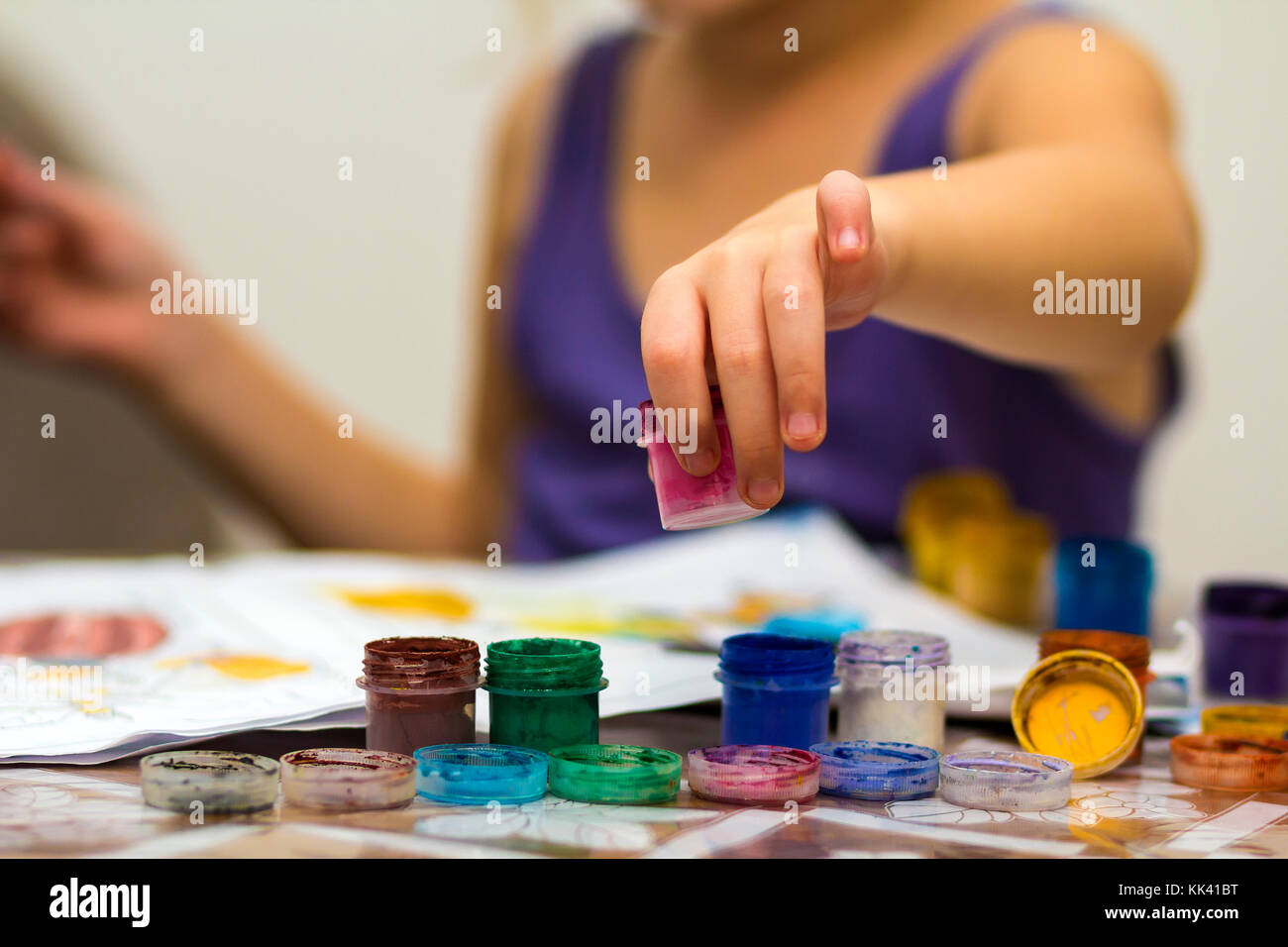 Cute little girl painting with brush and colourful paints Stock Photo ...